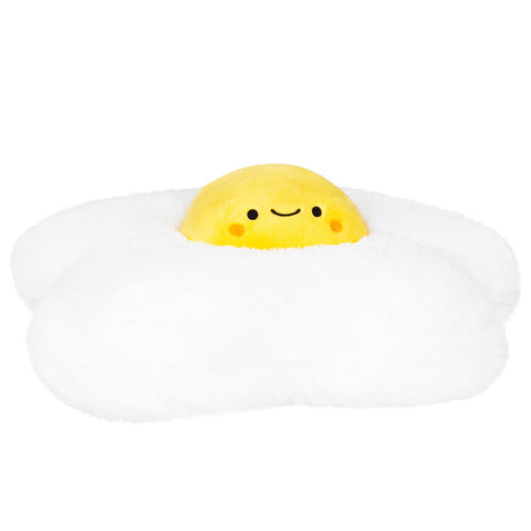 A plush toy resembling a fried egg with a smiling yolk, white exterior, and yellow interior.