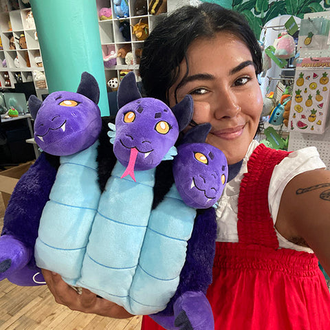 A woman holds the plush Hydra. It is about the size of her torso.
