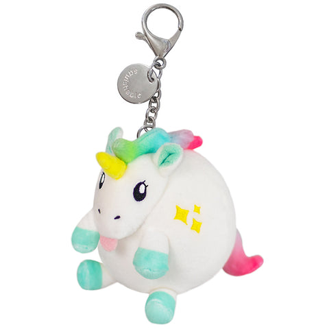 A small plush toy resembling a baby unicorn with multicolored hair, a white body, and teal hooves. It has a keychain clip and is pictured against a white background.