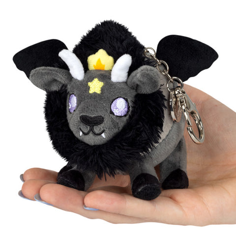 A plush toy resembling a Baphomet fantasy creature with a black body, gray details, and a metal clip for a keychain.
