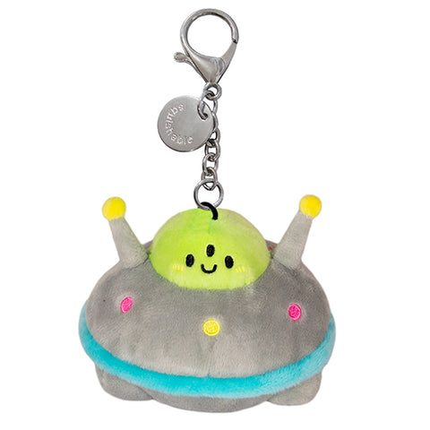 A plush toy resembling a micro UFO with a happy facial expression, featuring green, gray, blue, and yellow colors, and a metal clip for a keychain.