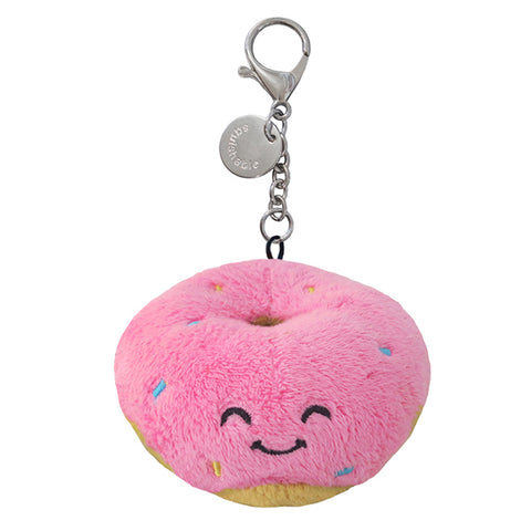 A plush toy in the shape of a pink donut with a happy face, attached to a silver clip keychain