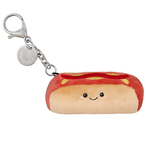 A plush hot dog with a happy face attached to a silver clip keychain
