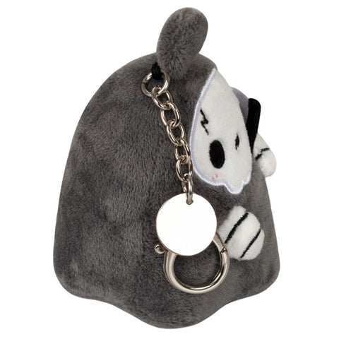 A side view of the plush reaper keychain