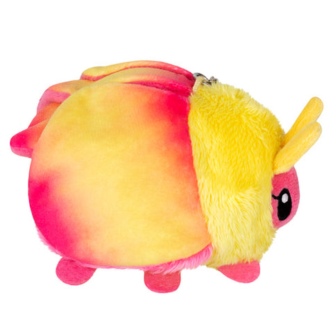 A side view of the plush rosy maple moth keychain