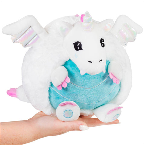 A round-bodied plush white dragon with a blue belly and white horn and wings.