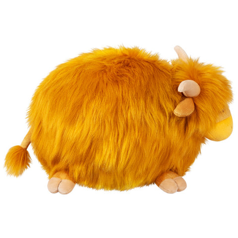 A side view of the plush highland cow. Its body is very round.
