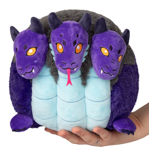 A purple, grey, and blue three headed dragon resembling the mythical Hydra held in someone's hand