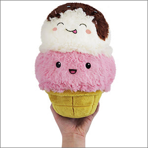 A hand holds a plush ice cream cone with strawberry & vanilla ice cream and chocolate drizzle.