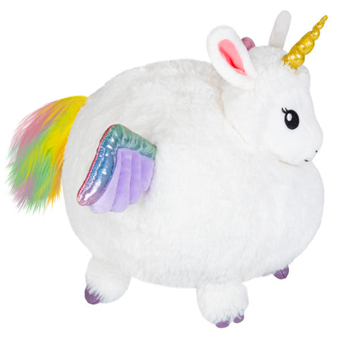 A side view of the plush llamacorn. Its wings are purple, and its tail is rainbow colored.