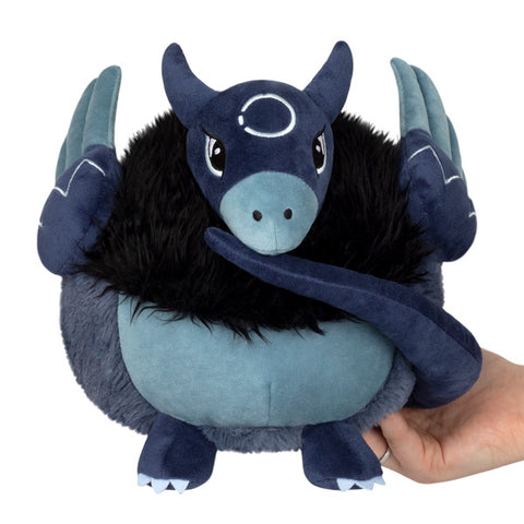 A mythical bird-like creature with blue fur, a black mane, and long navy blue tail