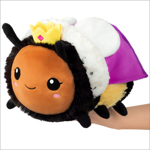 A plush bumblebee in a queen's outfit. It wears a crown and a purple robe.