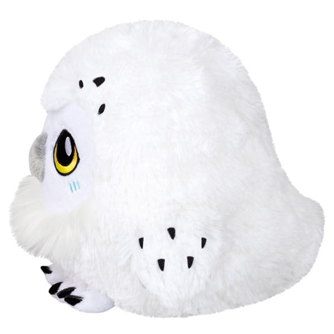 A side view of the plush snowy owl