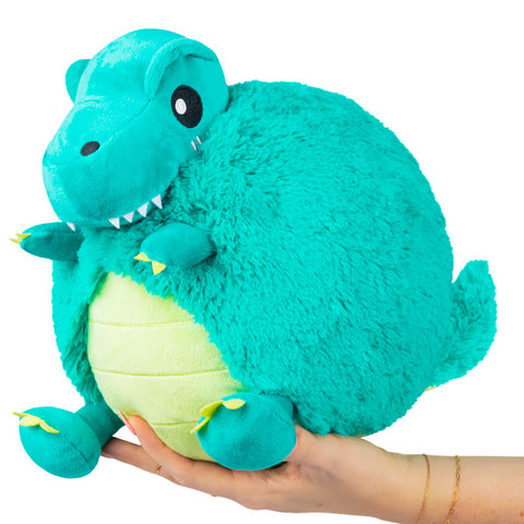 A turquoise and yellow plus T-Rex held in someone's hand