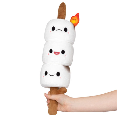 Image shows three stuffed marshmallows on a stick. The bottom two marshmallows are happy, the top is on fire.