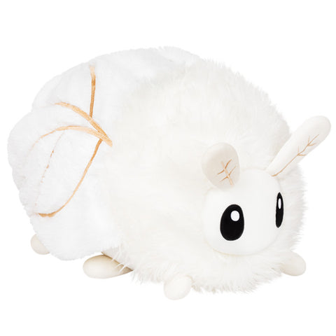 A plush toy resembling a white poodle moth with brown accents on its wings and large black eyes, lying on a plain background.