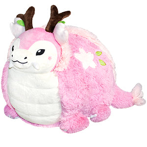 A plush pink, cherry blossom-themed dragon. Its body is very round.