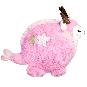 A side view of the plush Sakura dragon. Its body is very round.