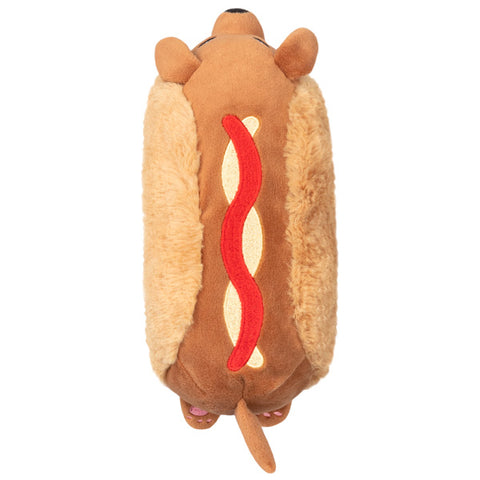 A top-down view of the plush Dachshund hot dog. It has a ribbon of ketchup and mustard