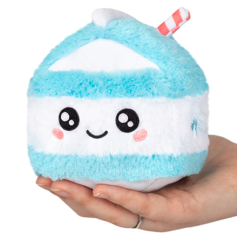 A plush toy designed to resemble a blue and white striped milk carton with a cute face on it, being held in a person's hand.