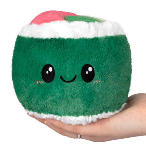 A green plush sushi roll with a happy face held in someone's hand