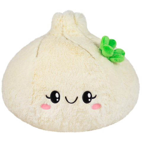 A plush soup dumpling with a happy face on a white background
