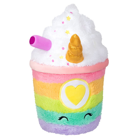 A plush rainbow-colored latte with whipped cream, a happy face, and a gold unicorn horn