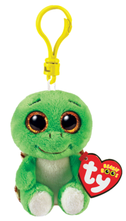Image shows a stuffed turtle with large golden plastic eyes hanging from a yellow plastic clip