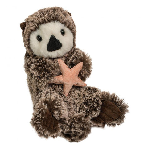 Image shows a fuzzy stuffed sea otter holding a light orange starfish.