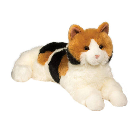 Image shows a stuffed orange, black, and white calico cat. It is laying down.